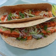 Two baja salmon tacos on a plate. 