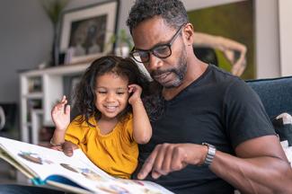 adult male reading to child